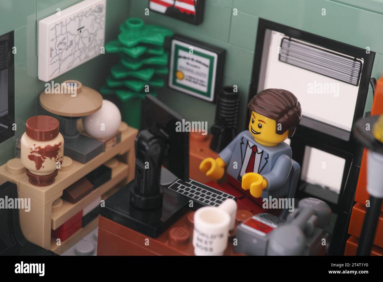 Tambov, Russian Federation - November 01, 2023 A Lego businessman minifigure sitting and working behind a computer in an office. Close up. Stock Photo