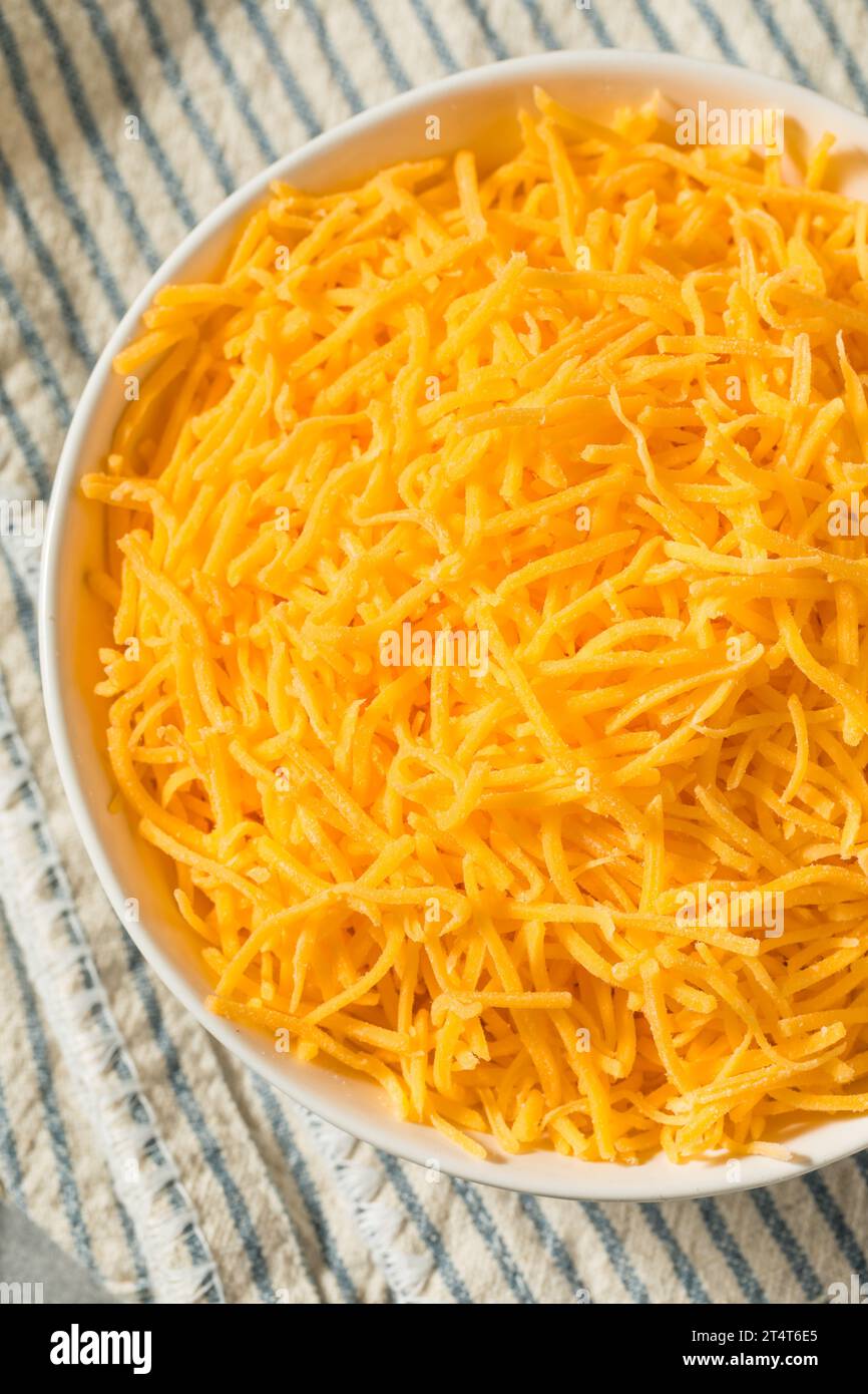 Plastic container with grated cheese on table Stock Photo - Alamy