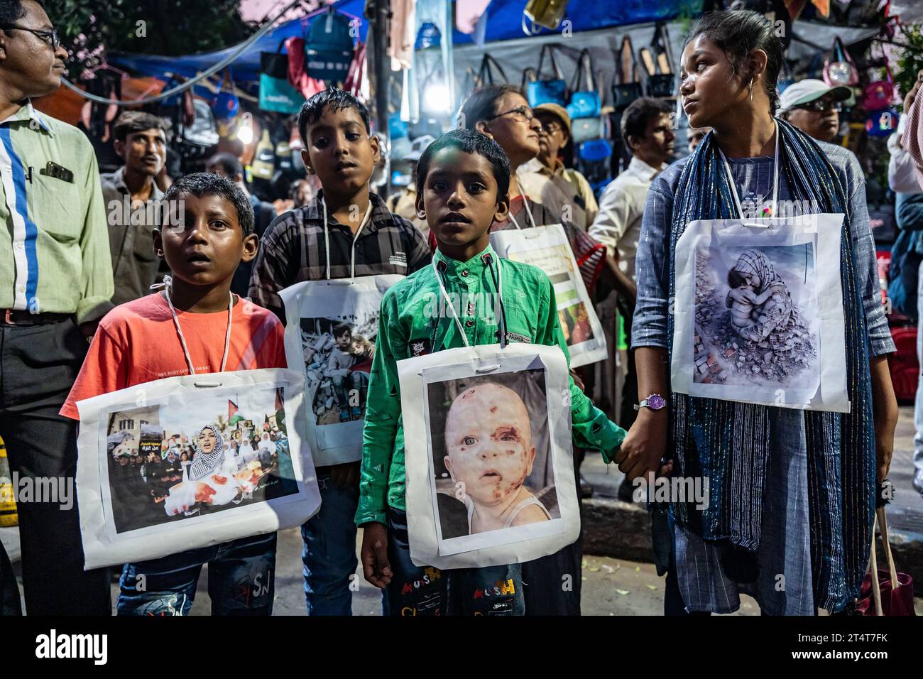 Kolkata, India. 01st Nov, 2023. Children hold pictures of wounded and dead Palestinian children during the demonstration. Activists from various organizations of Kolkata India staged rallies to protest against Israel and in solidarity with Palestine. Children also took part in the rallies to protest against the death of children in Palestine. Protesters also burnt the effigy of Benjamin Netanyahu (Prime minister of Israel) & Joe Biden (U.S President) on the street. Credit: SOPA Images Limited/Alamy Live News Stock Photo