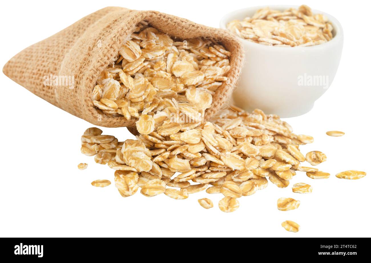 Whole oats in jute sack and a bowl Stock Photo