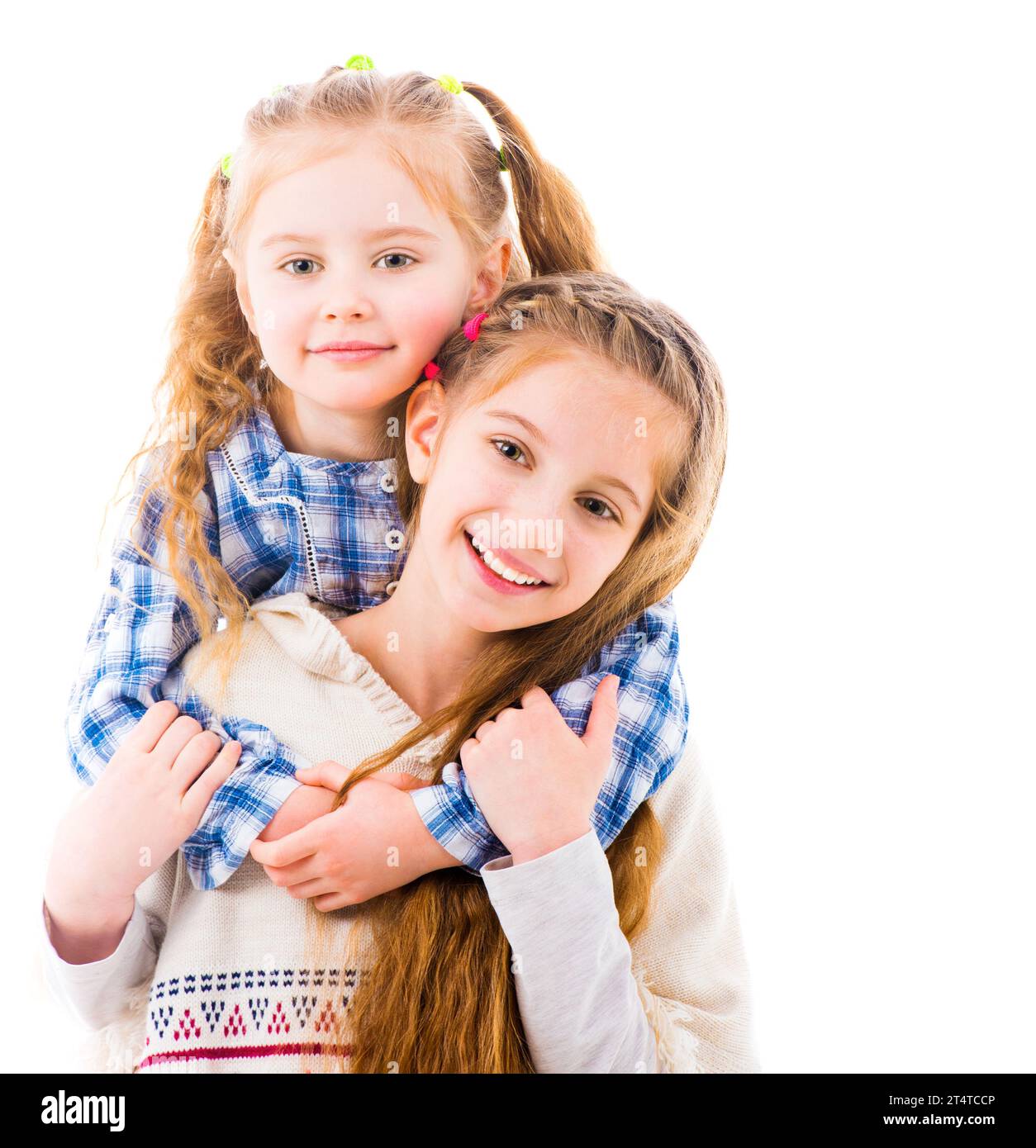 Two little girls sisters in casual clothes posing and hugging each ...