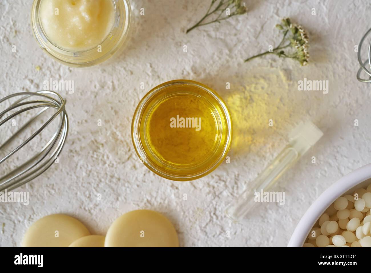 Essential oil with shea butter, beeswax pellets and cocoa butter on