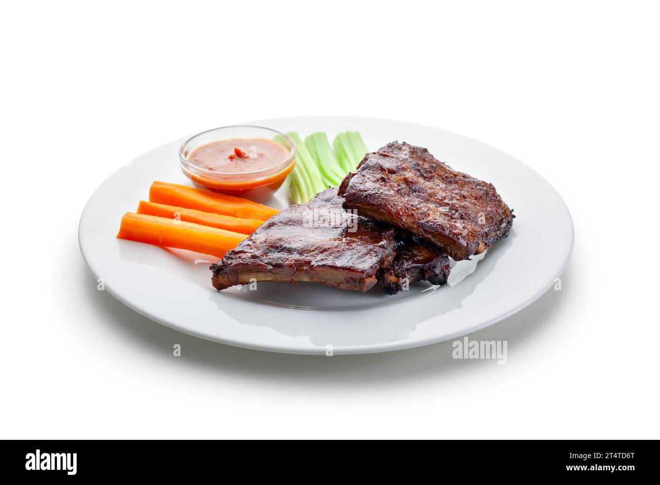 BBQ ribs, carrot, stalked celery, meat with vegetable, dressing Stock Photo