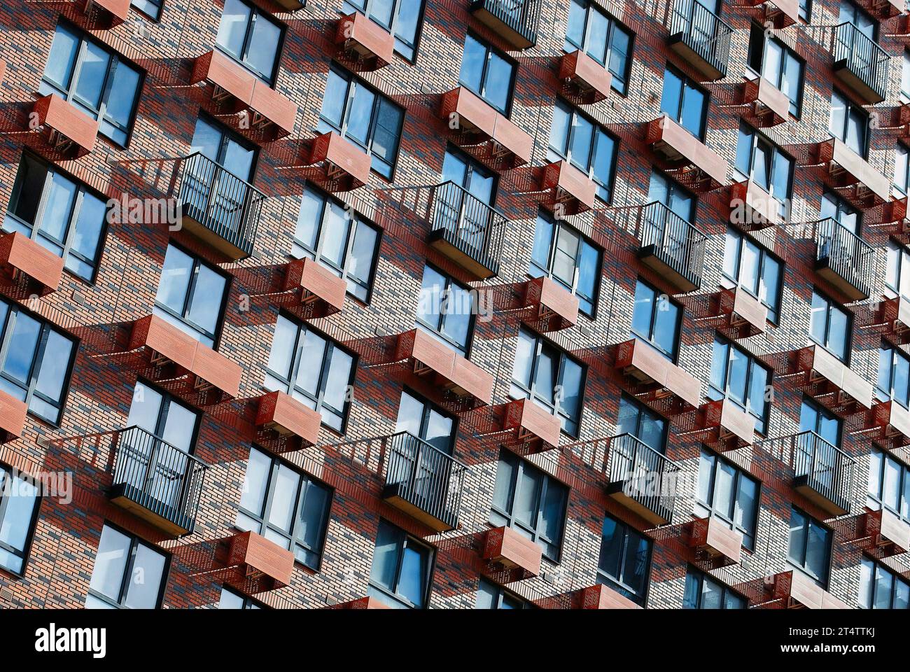 Facade of a modern apartment building with balconies and red brick ...