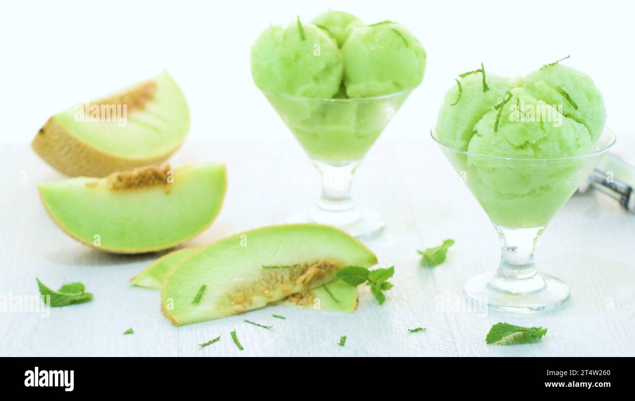 Close up of melon flavored icecream with mint and melon on a white