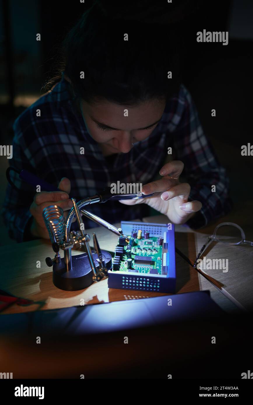 Mother Computer Programmer Woman, computer motherboard and night with soldering iron ...