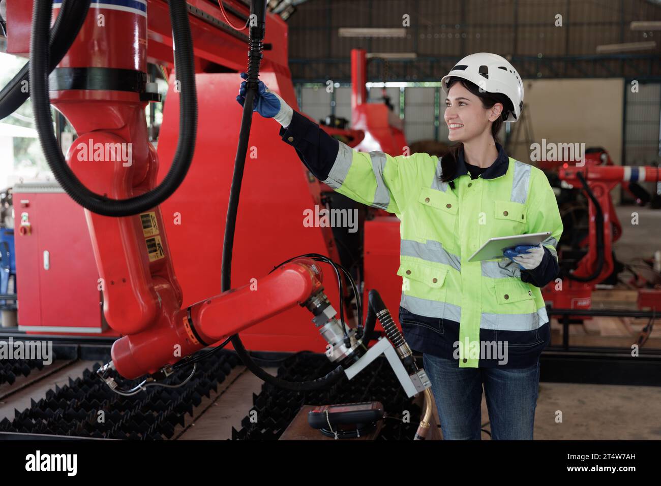 Female automation engineer wear vest with helmet safety checking and