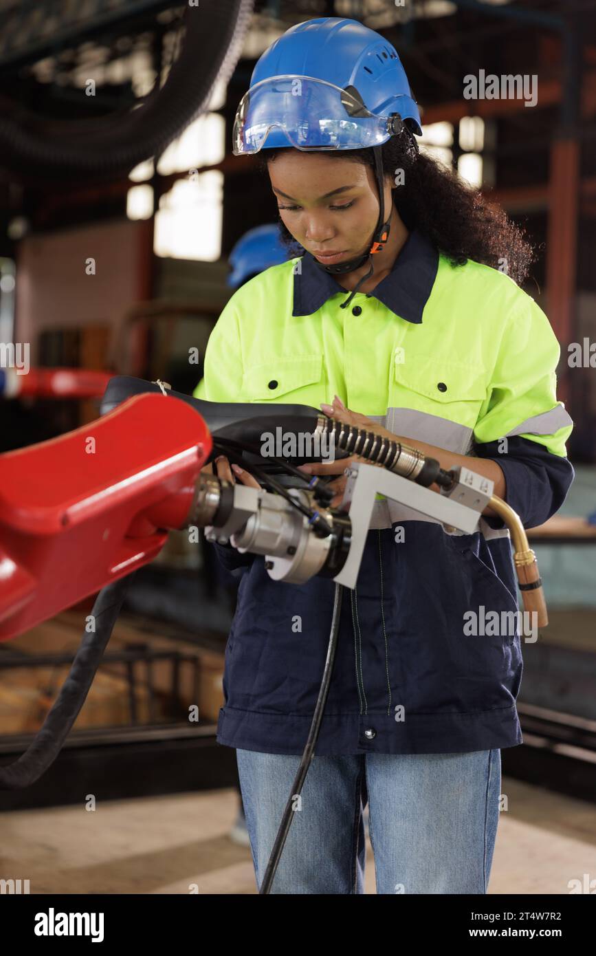 Female automation engineer wear vest with helmet safety checking and