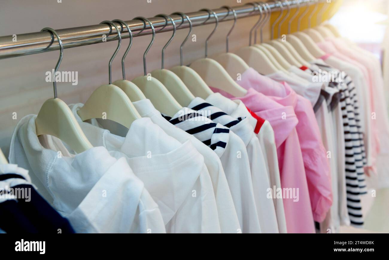 Row of children clothes on hangers Stock Photo