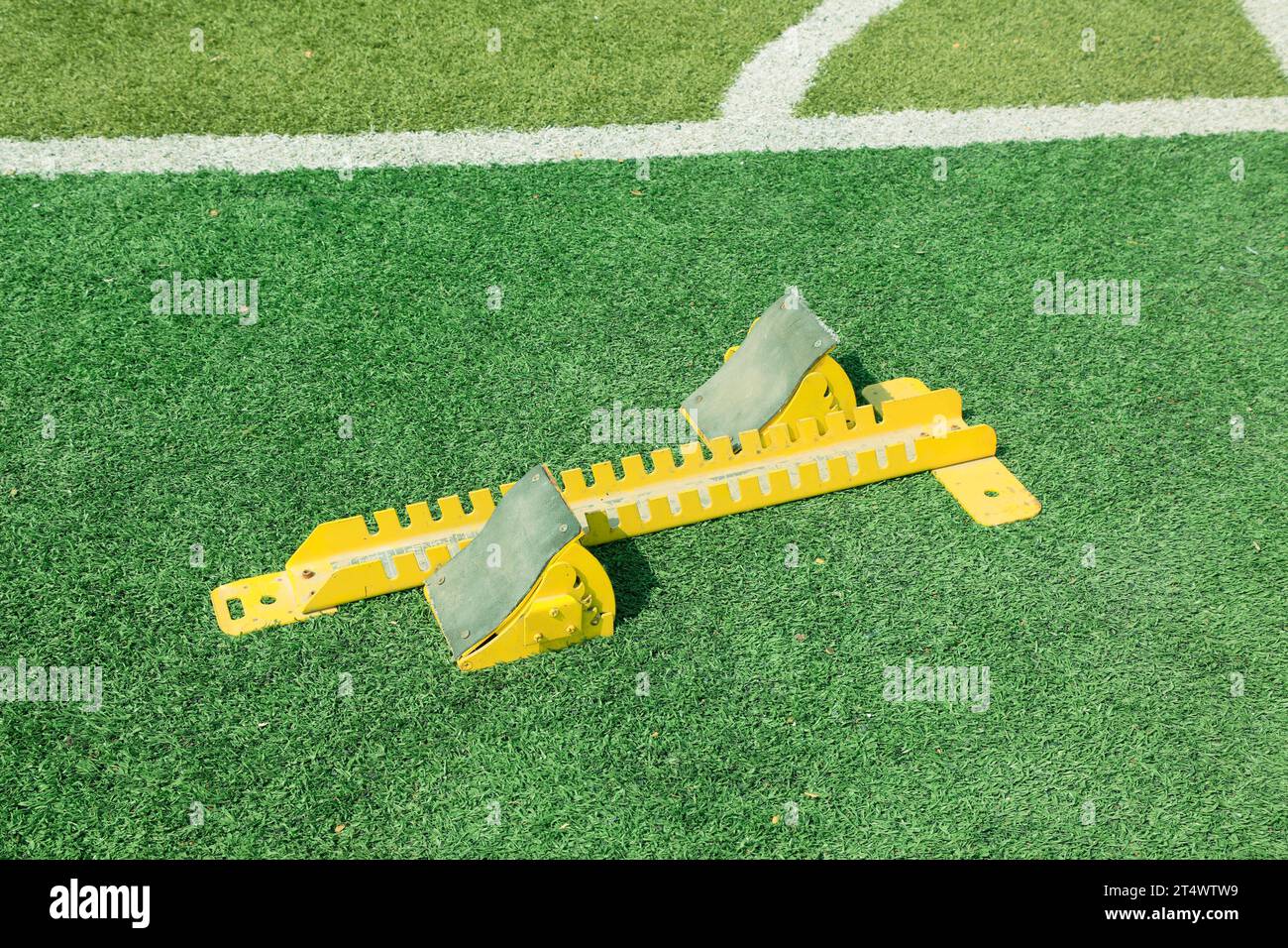 Starting blocks in the green plastic on the playground Stock Photo - Alamy