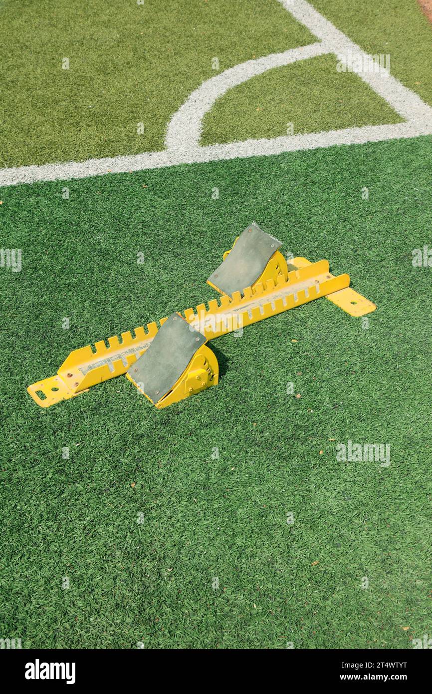 Starting blocks in the green plastic on the playground Stock Photo - Alamy