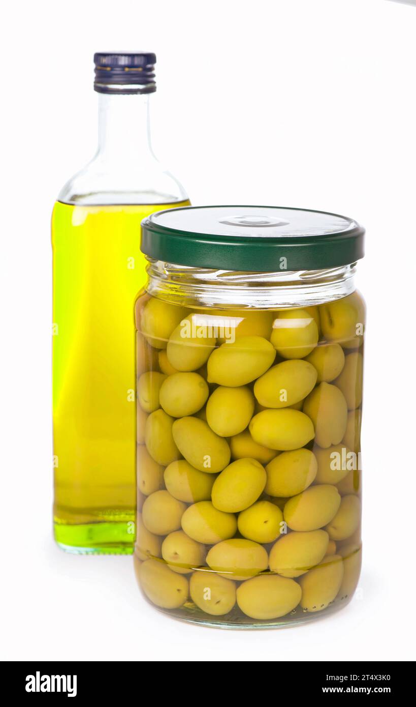 Green olives preserved in bank and a bottle of olive oil isolated on a white background Stock