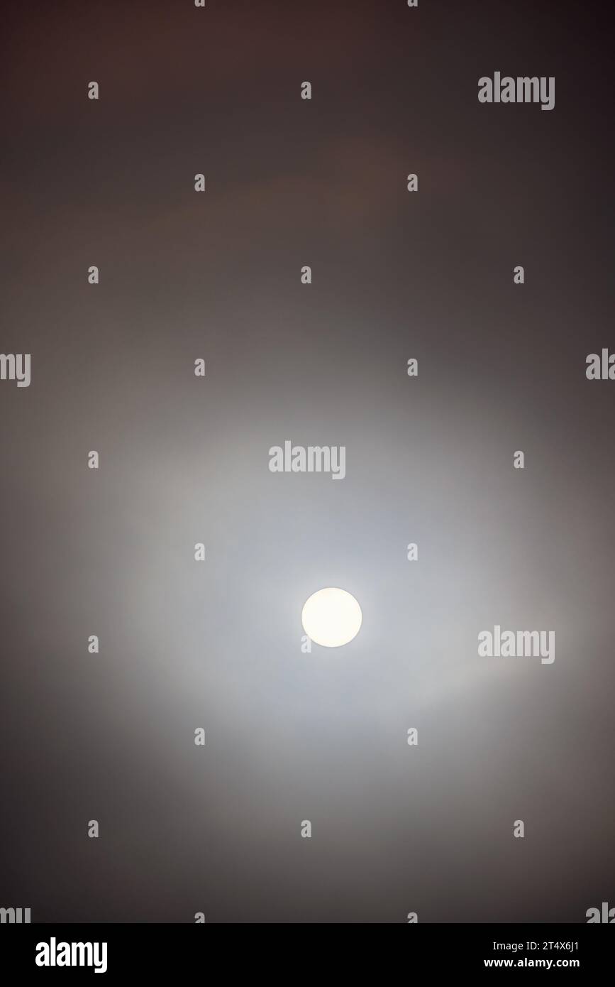 Sun shining through the dark clouds in the sky Stock Photo