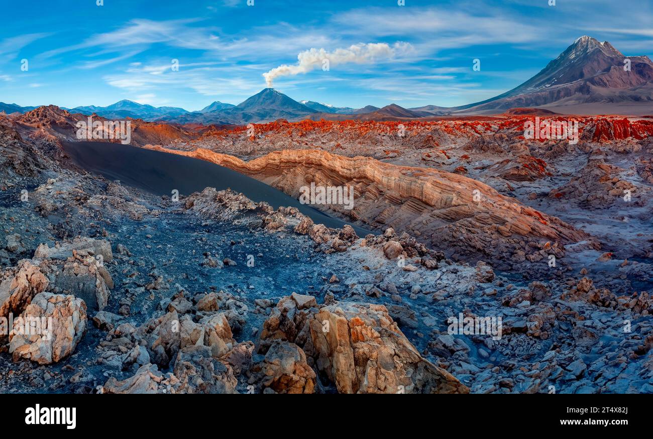 Mount Licancabur Volcano and colorful mineral deposits. Viewed from Valle de la Luna in the Atacama Desert region of northern Chile, South America. Stock Photo
