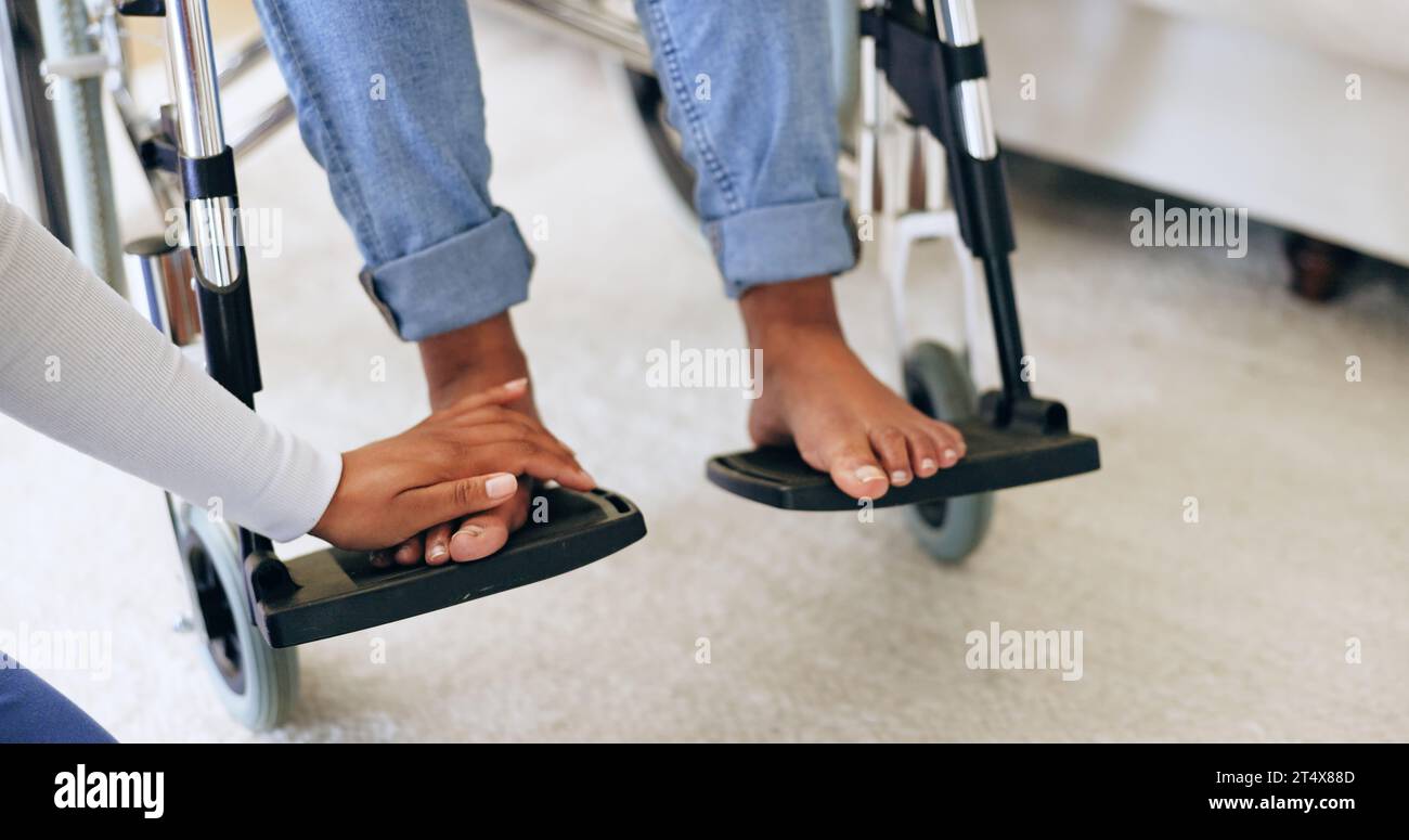 Hand, doctor and feet in wheelchair with help in home for recovery