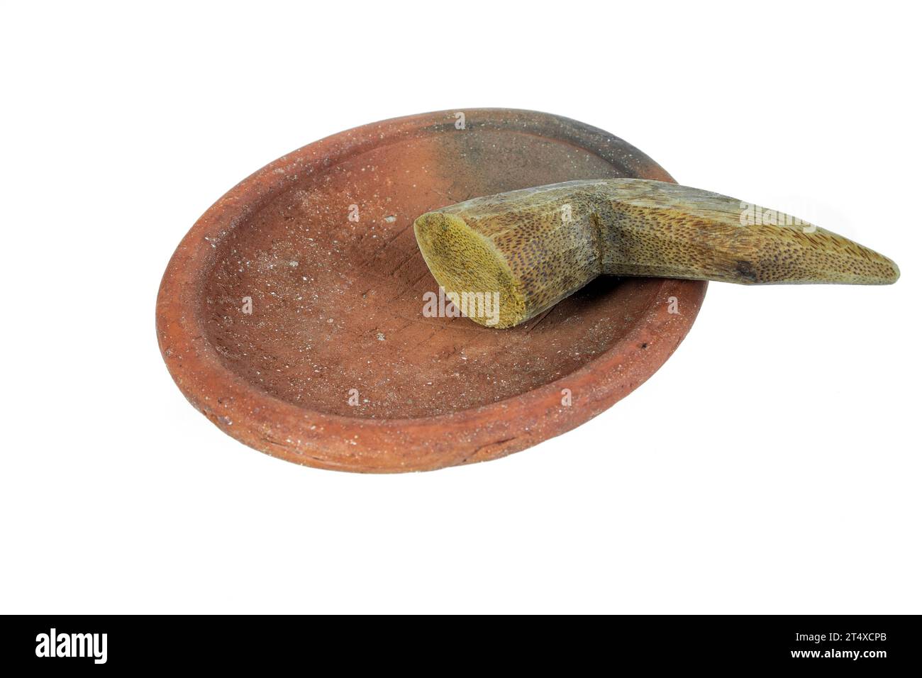 Traditional mortar and pestle made of clay and wood on a white