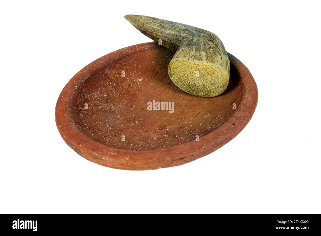 Traditional mortar and pestle made of clay and wood on a white