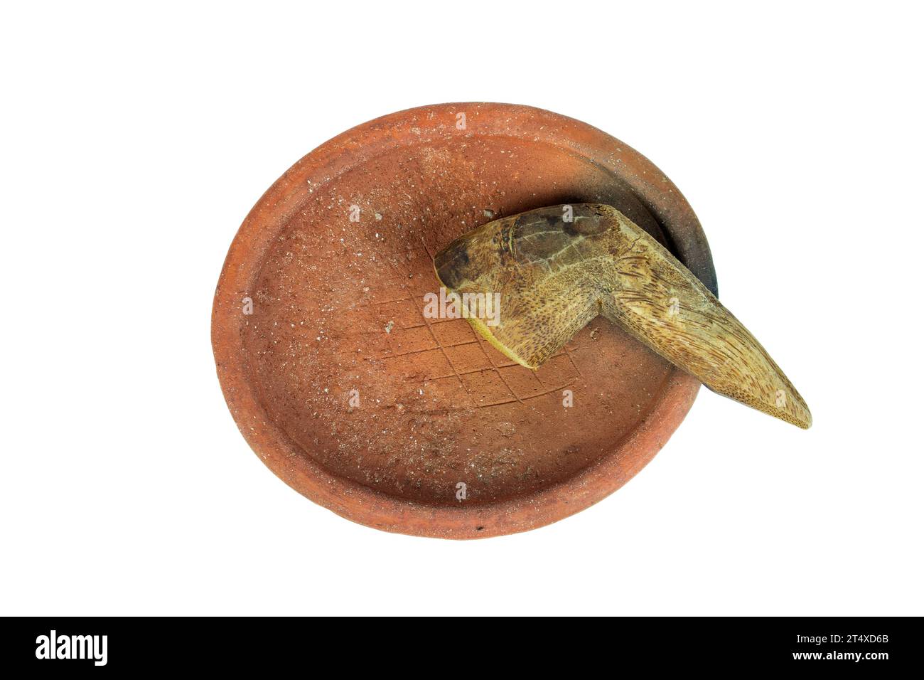 Traditional mortar and pestle made of clay and wood on a white