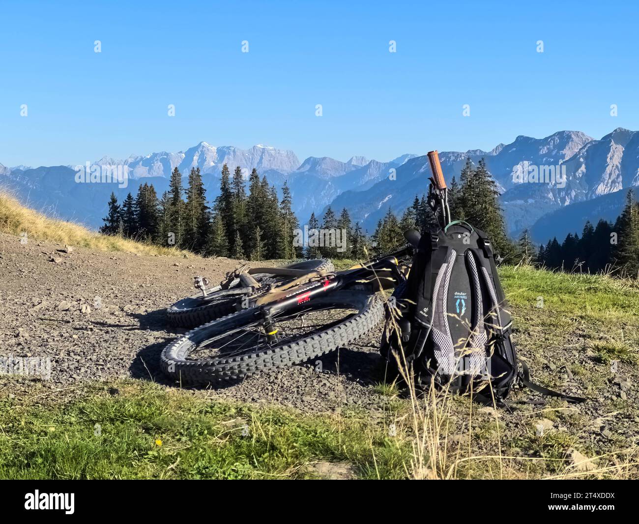 Hiker walking up to Edelsberg peak with Sportheim Böck mountain hut and a view on Zugspitze mountain in Nesselwang, Germany, Sept 25, 2023. Stock Photo