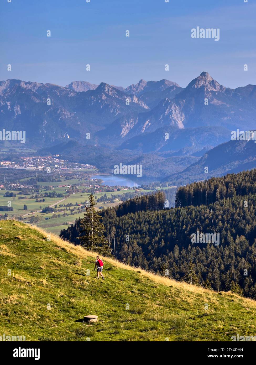 Hiker walking up to Edelsberg peak with Sportheim Böck mountain hut and a view on Zugspitze mountain in Nesselwang, Germany, Oct 13, 2023. Credit: Imago/Alamy Live News Stock Photo