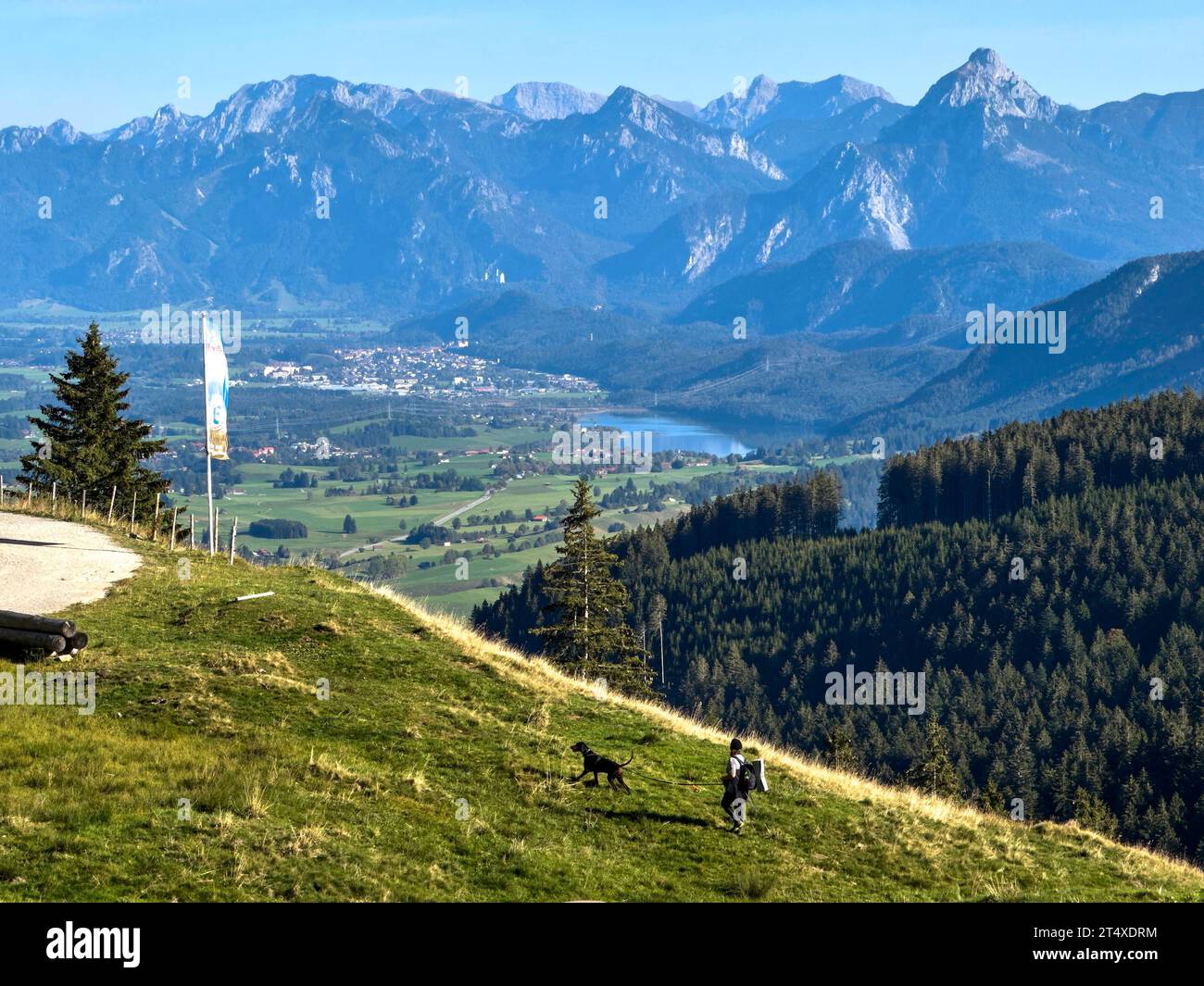 Hiker walking up to Edelsberg peak with Sportheim Böck mountain hut and a view on Zugspitze mountain in Nesselwang, Germany, Oct 13, 2023. Credit: Imago/Alamy Live News Stock Photo