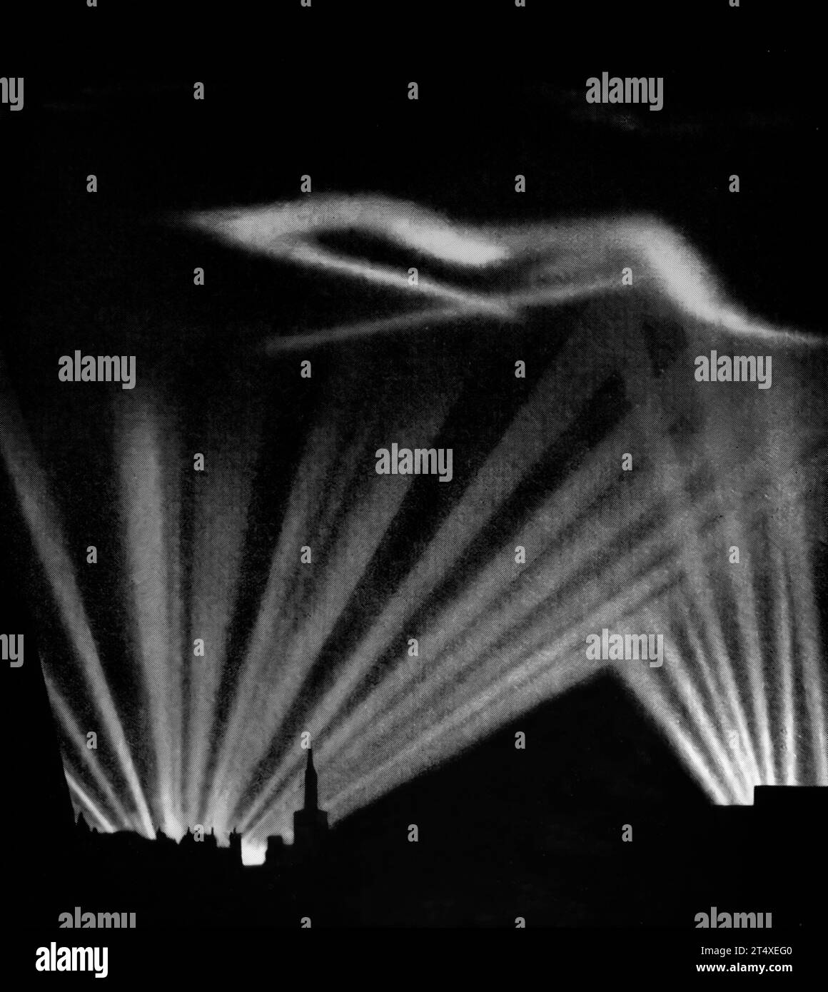 Shortly after midnight on the 21st August 1940, the first bombs were dropped by the Luftwaffe on London, England. Continuing for many nights, the darkness was lit by patterns of searchlights. Stock Photo