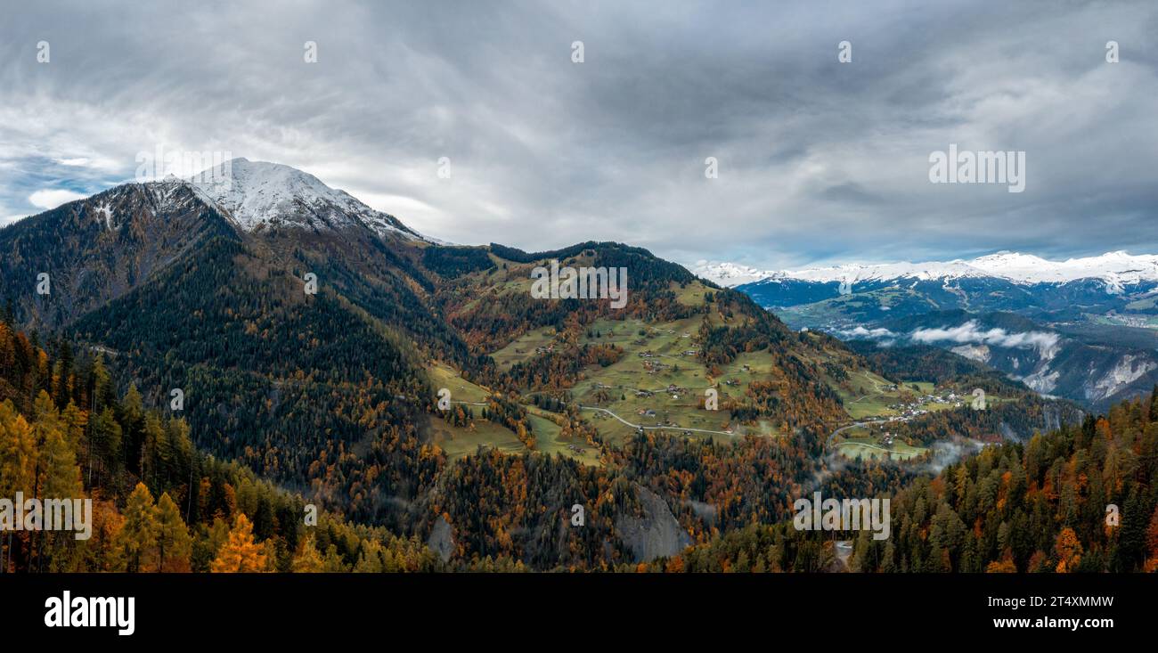 panorama mountain landscape in the Swiss Alps with snow-capped peaks and autum color forest Stock Photo