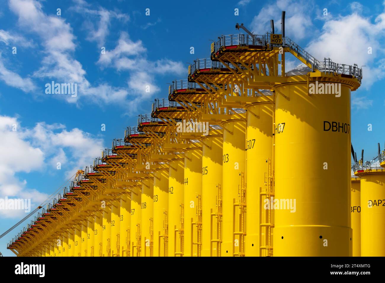 Rotterdam, the Netherlands-September 16, 2023; Low angle view of yellow transition pieces on construction site of SIF company a steel tubular manufact Stock Photo