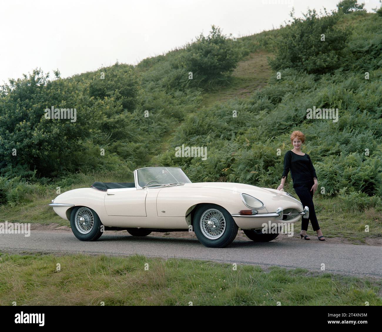 Early publicity photo of Jaguar E-type S1, Open Two-Seater, 3.8L, with model in black slacks and black jumper.  Taken at Halesowen Golf Club on the 21 Stock Photo