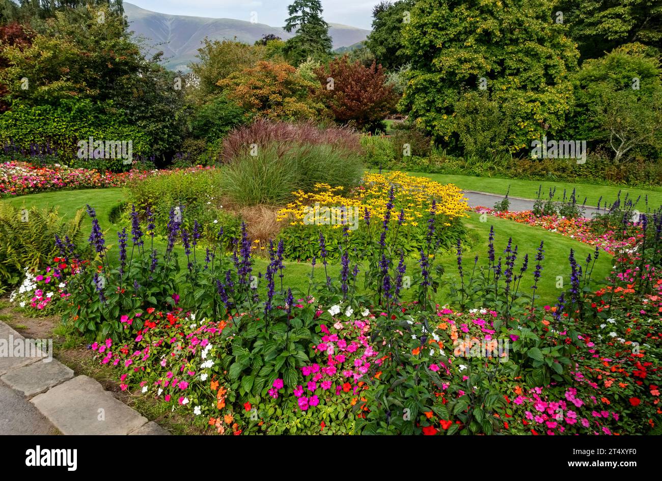 Colourful flowerbeds flowers in Hope Park public garden gardens in summer Keswick Cumbria England UK United Kingdom GB Great Britain Stock Photo