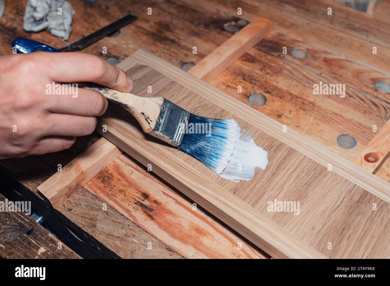 Varnishing a wooden drawer, carpentry Varnish is applied to a