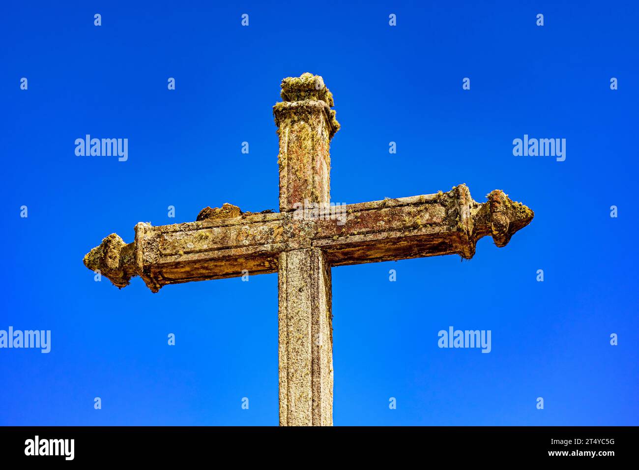 Old baroque crucifix deteriorated by time in Lavras Novas, Minas Gerais Stock Photo