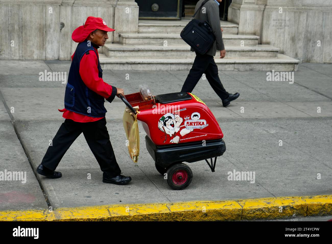 Ice Cream seller pushing a trolley through Lima Old Town. Lima, Peru. Stock Photo