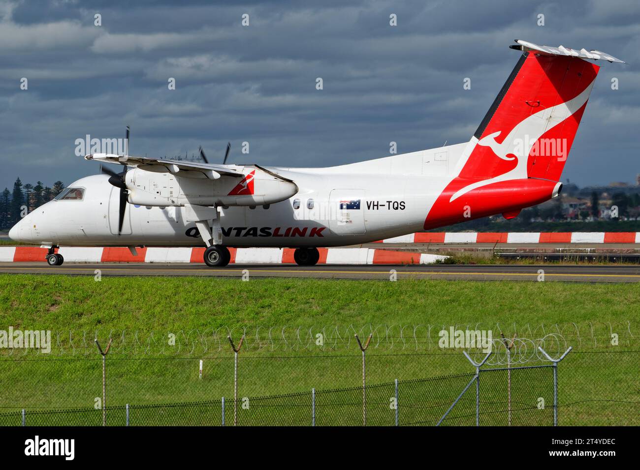 QantasLink De Havilland Canada Dash 8-200 seen taxiing at Sydney Airport. Stock Photo
