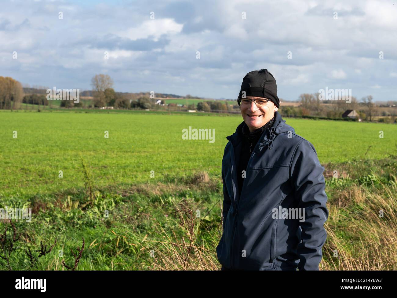 Active 45 yo white man with bonnet standing in the green fields around Gooik, Brabant, Belgium Credit: Imago/Alamy Live News Stock Photo