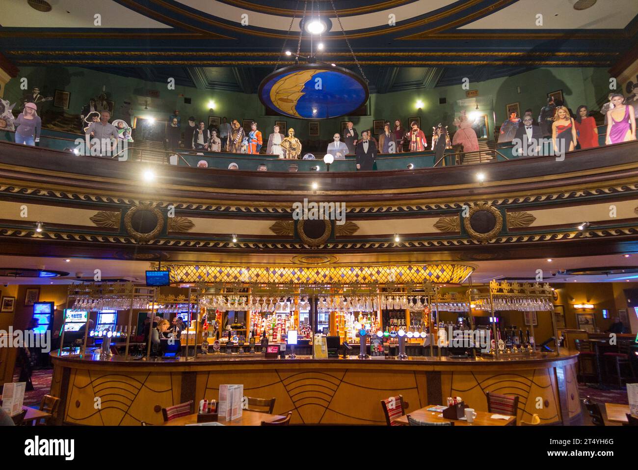 Circle seating & mannequins above bar inside The Playhouse Wetherspoon
