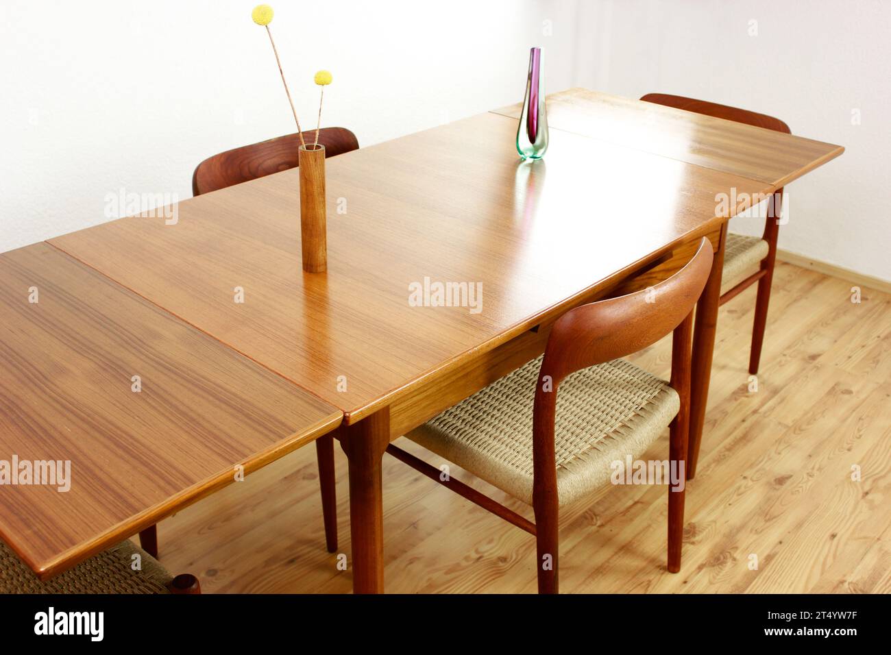 A Mid Century Teak Dining Table with four chairs from the 50s 60s Danish Design Vintage Dining solid wood Modern antique 50s 60s isolated on white wal Stock Photo