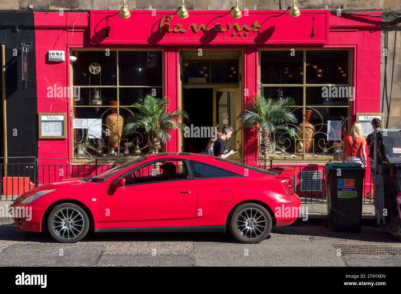 Daika Kurdish Grill with a red car in front of it, 3 Johnston Terrace, Edinburgh EH1 2PW, UK. Stock Photo