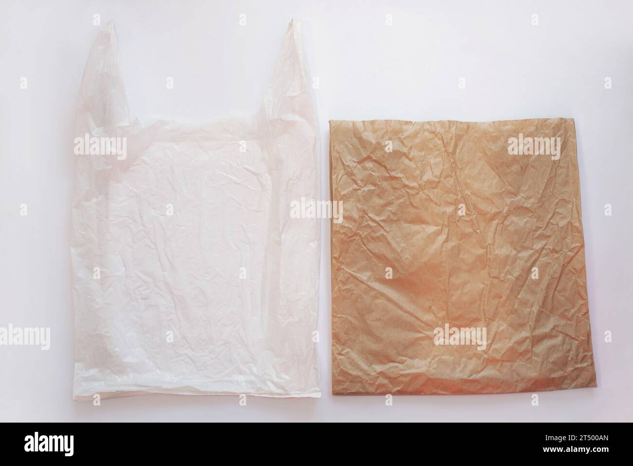 Blank plastic bag vs brown recyclable paper pack. Say no to plastic