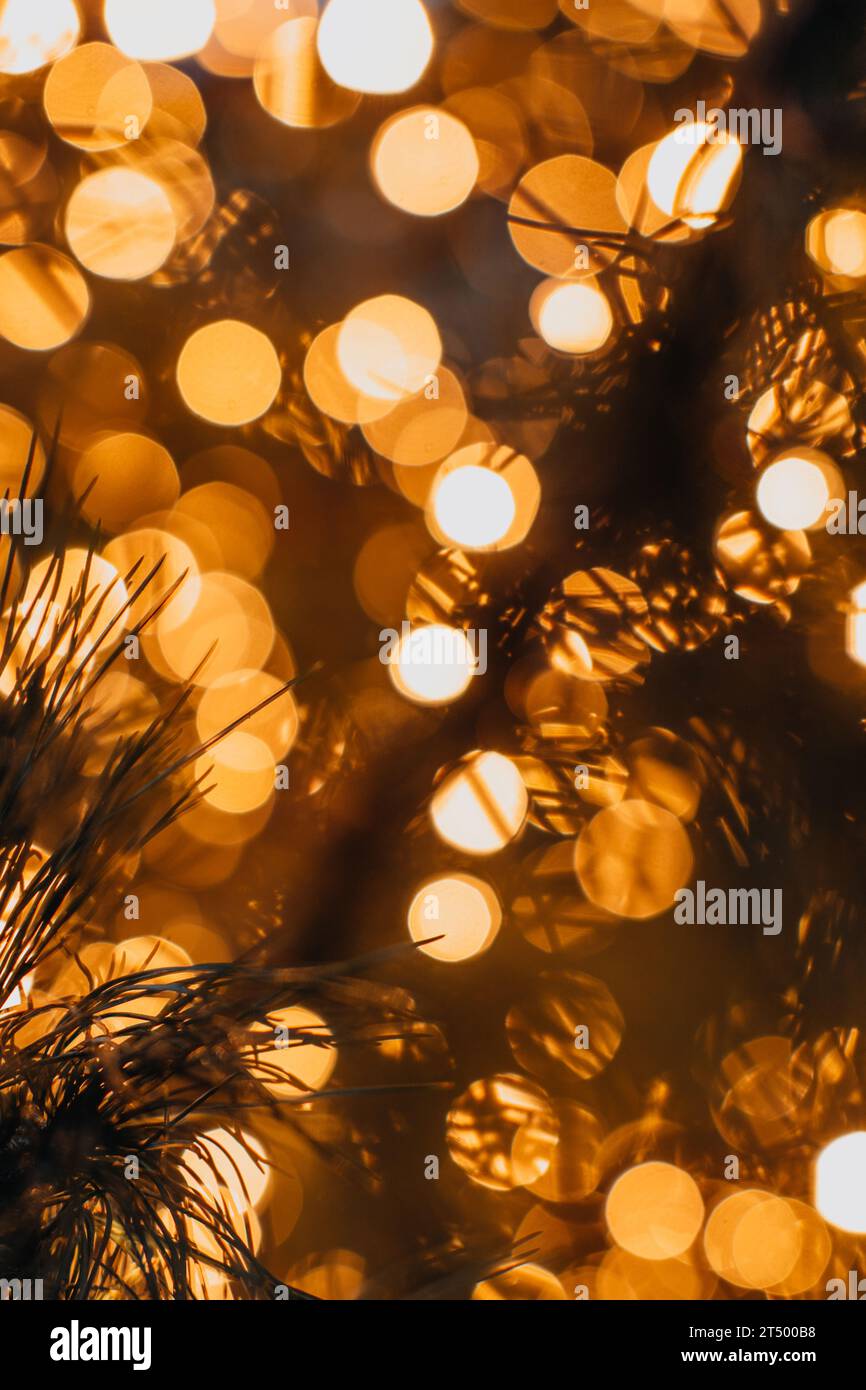 New Year sparkling background for greeting card. Golden magic glittering bokeh lights of festive Christmas garland. Stock Photo