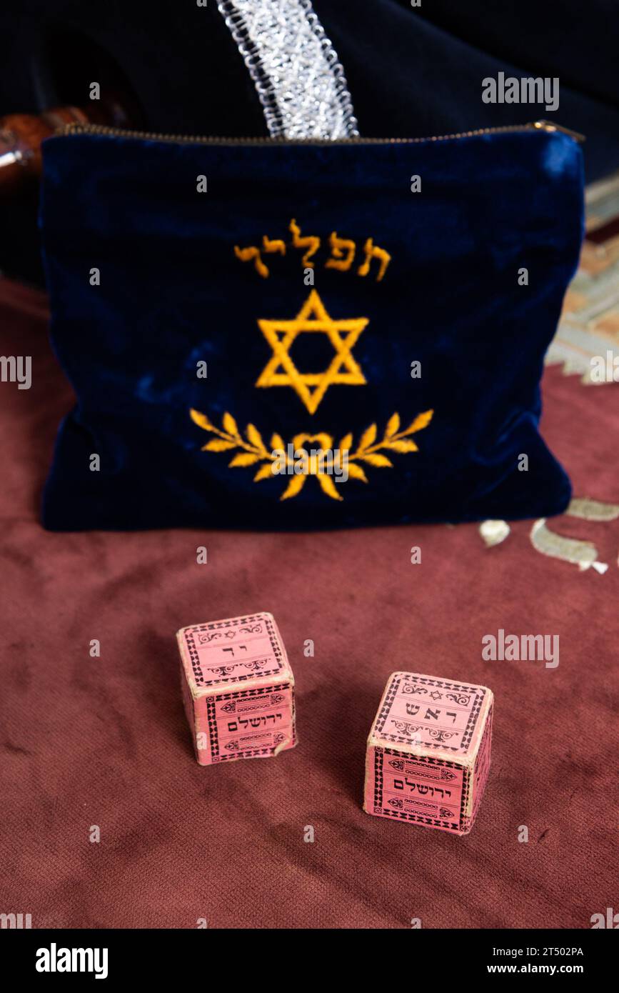 A blue felt bag with the Hebrew word "tefillin" embroidered with a