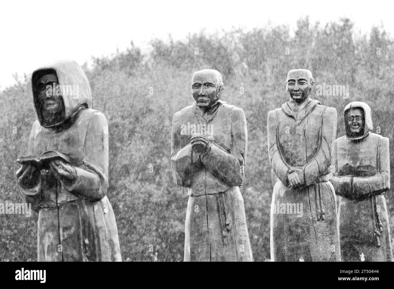 Life size, carved wooden sculptures of the Monks of Meaux (Hull) East Yorkshire, in procession on a wet day in October Stock Photo