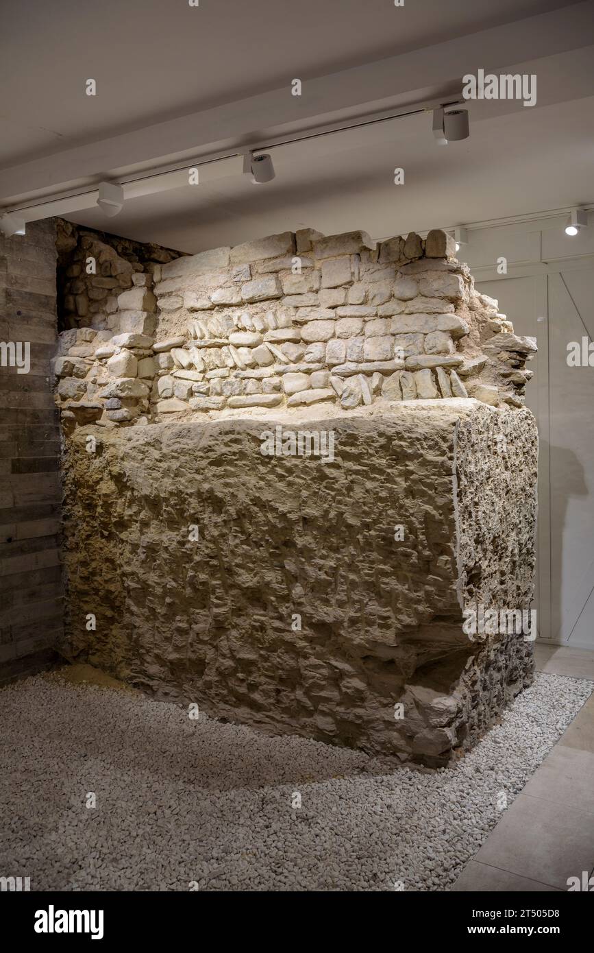 Section of the northern wall of Vic preserved and can be seen in the background of the La Casa de las Carcasas store (Vic, Osona, Barcelona, Spain) Stock Photo