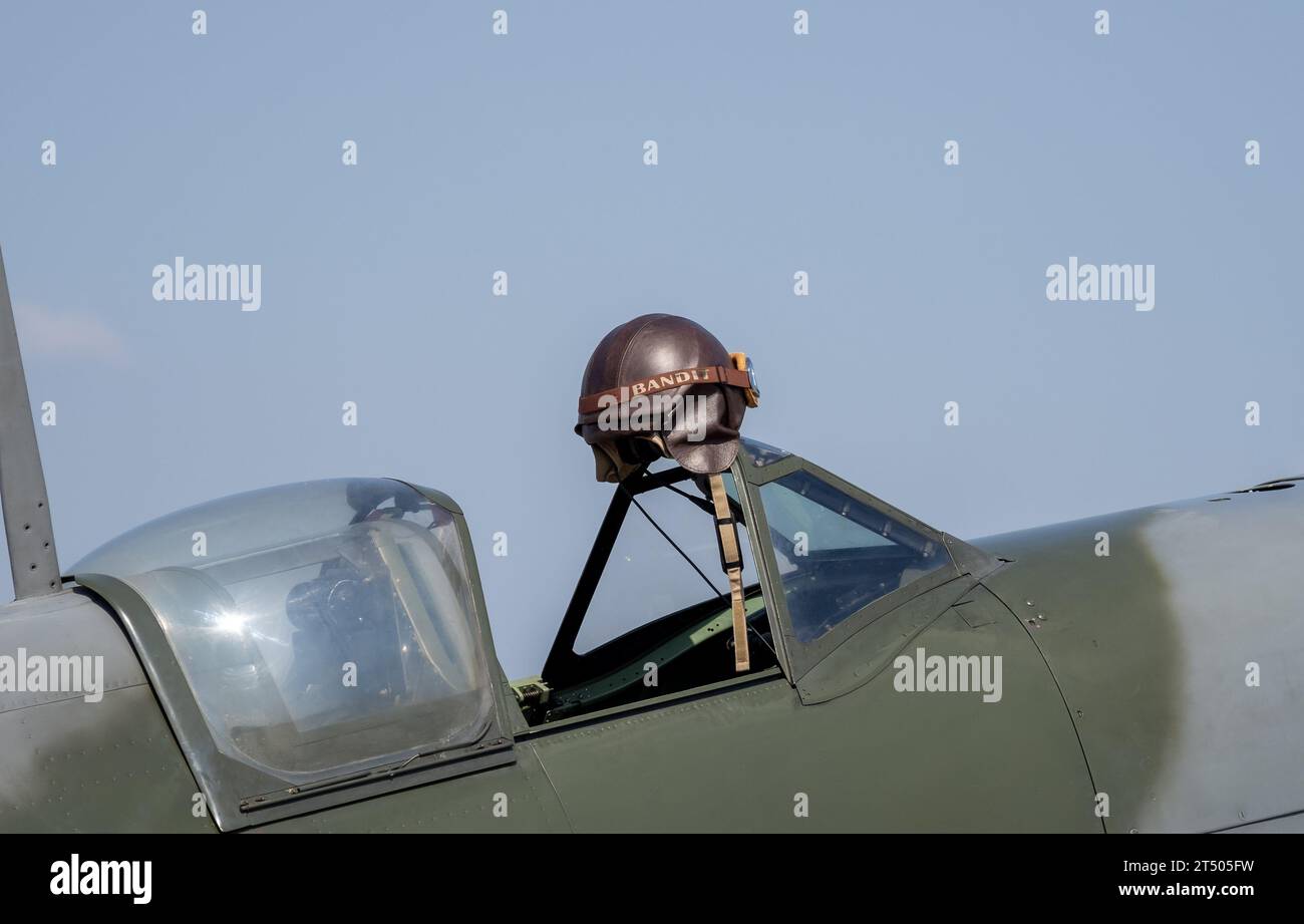 A pilot helmet hanging. Close up of  a Spitfire with cockpit canopy open Stock Photo