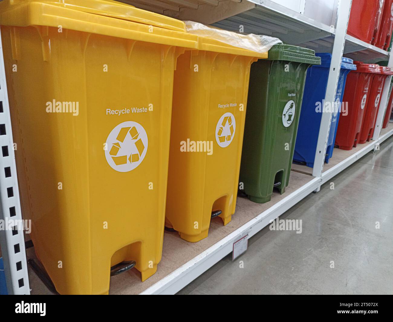 Trash cans of various colors separate types of garbage Stock Photo Alamy