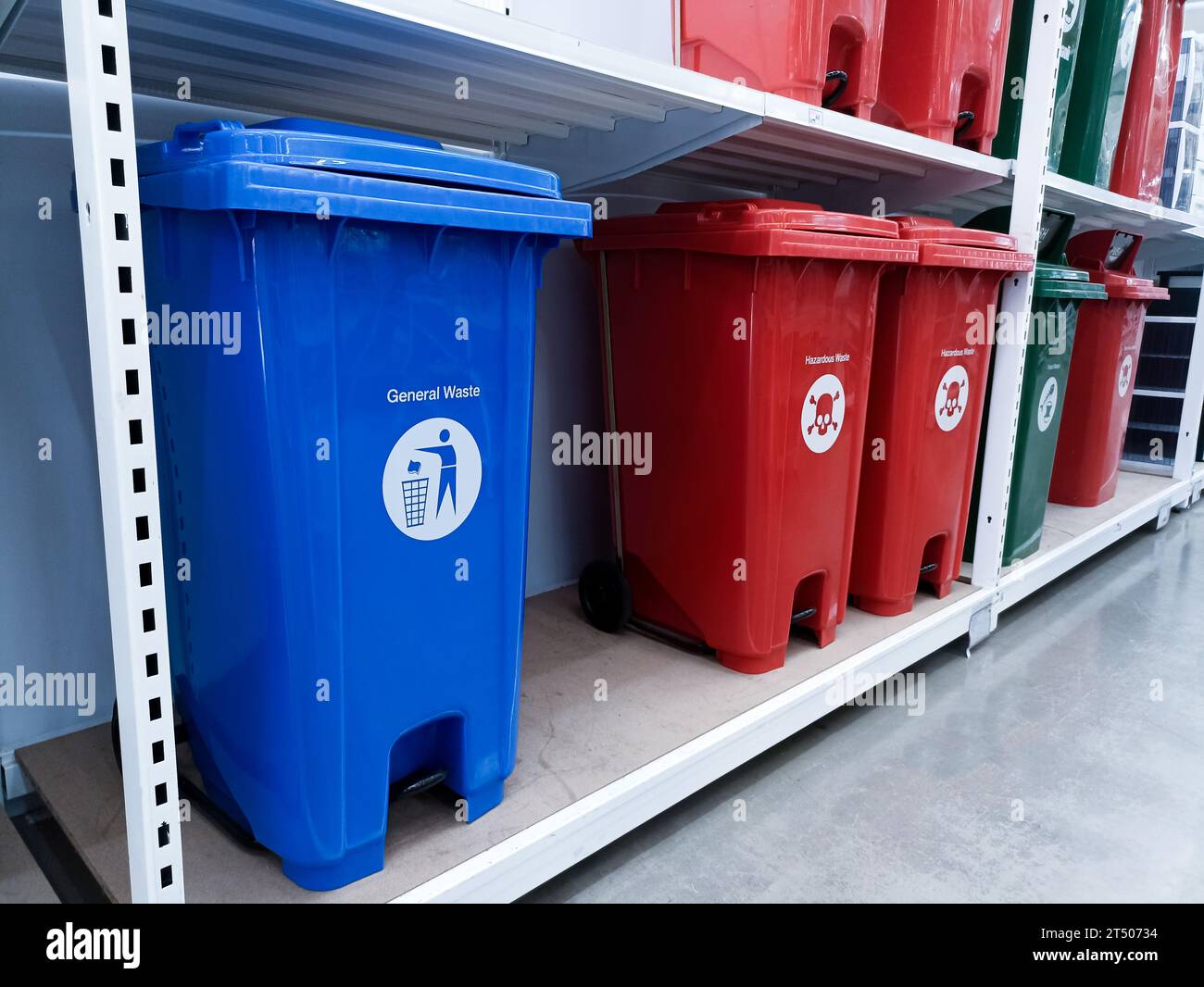 Trash cans of various colors separate types of garbage Stock Photo Alamy