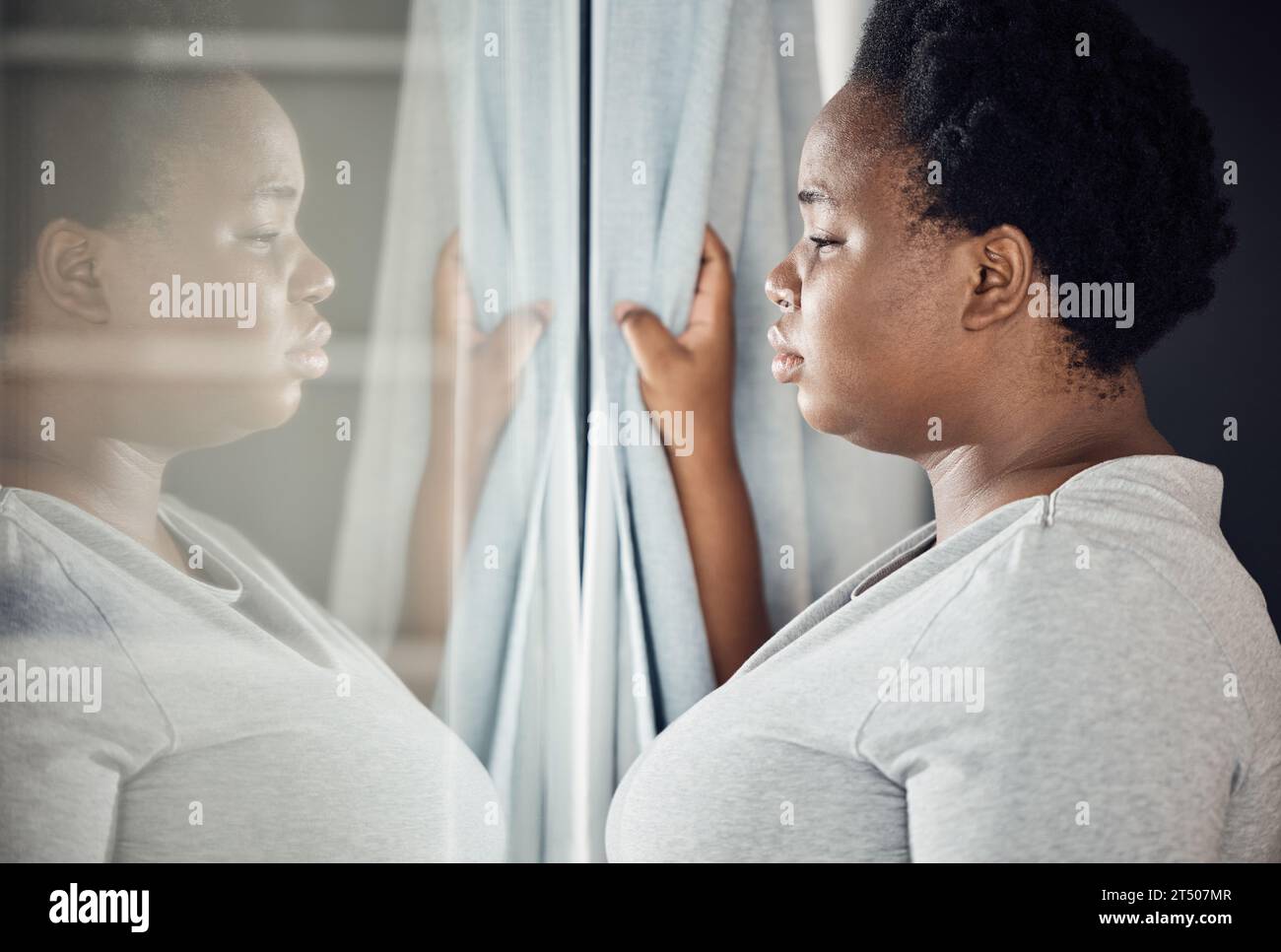 Window, thinking or black woman with depression, stress or mental health crisis by curtain at home. Worry, lonely lady or sad African person with Stock Photo