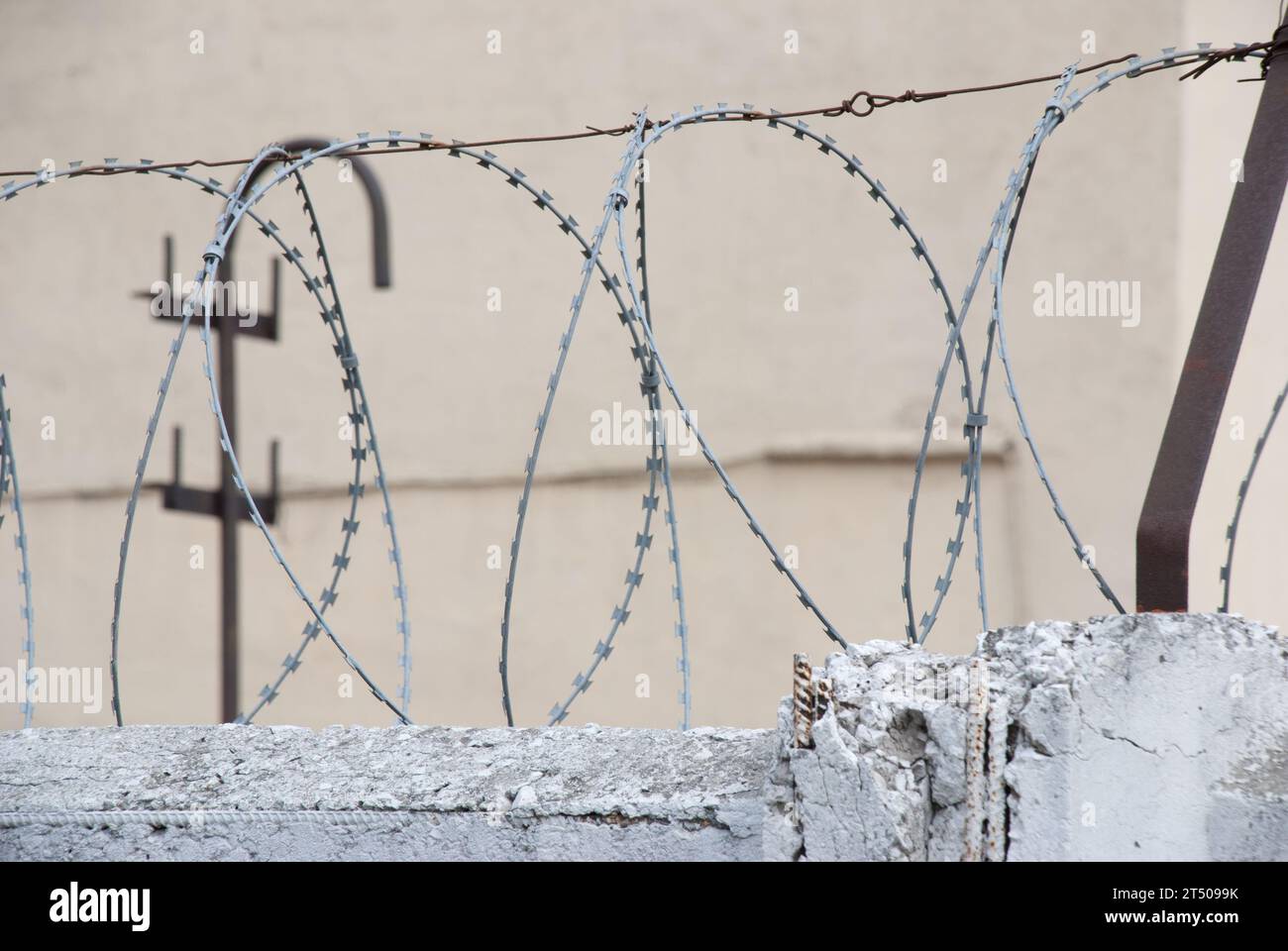 Barbed wire on the top of a fence Stock Photo - Alamy