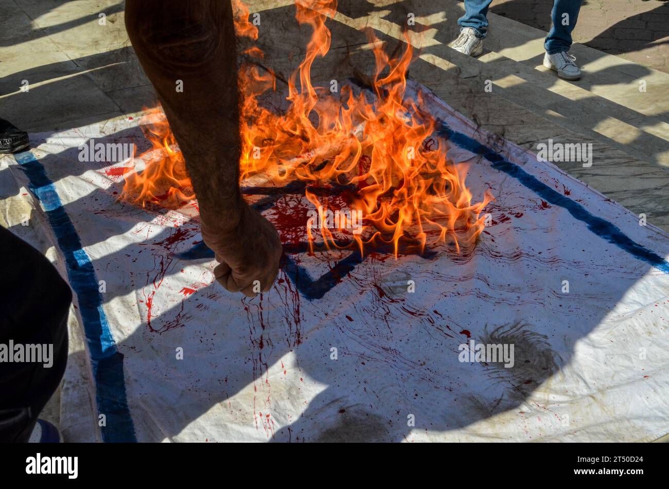 November 2, 2023: Tunis, Tunisia. 02 November 2023. Protesters burn a red-stained Israeli flag during a demonstration in Tunis in support of Palestinians and against the Israeli military offensive in Gaza. The demonstration takes place amid an extraordinary session of the Tunisian parliament discussing a draft law criminalising the normalisation of relations with Israel. If approved, the draft law would criminalise economic, cultural, and military ties with Israel (Credit Image: © Hasan Mrad/IMAGESLIVE via ZUMA Press Wire) EDITORIAL USAGE ONLY! Not for Commercial USAGE! Stock Photo