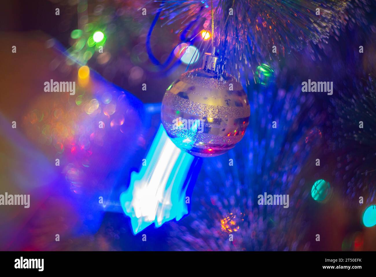 Christmas decorations and colored lights garlands on Christmas tree. Bright lights and highlights against background of Christmas decorations.. Stock Photo